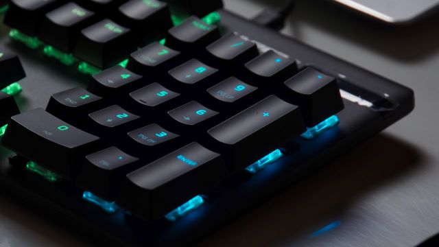 Numpad of a mechanical keyboard in blue and green lighting