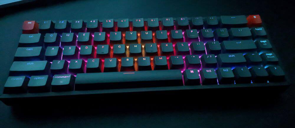 A mechanical keyboard on a desk with glowing RGB