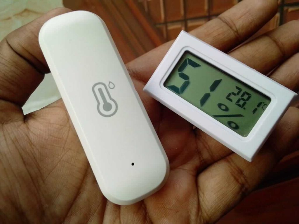 2 different digital temperature meter on a hand