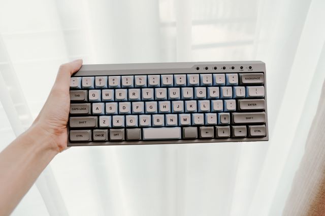 guy holding a mechanical keyboard